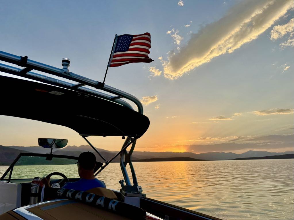 Boat and American flag at sunset
